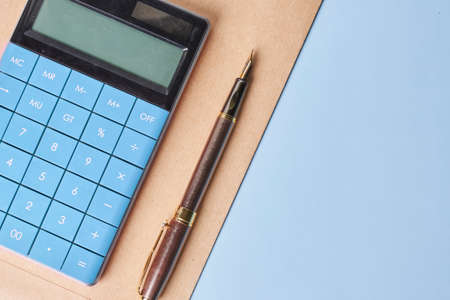 Envelope and financial documents with blue calculator on blue background. Close upの写真素材