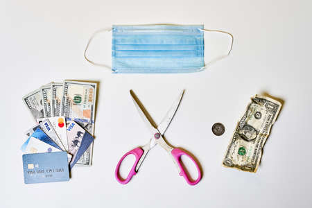 poor and rich concept with money on white background. Scissors and Money and home and just penniesの写真素材