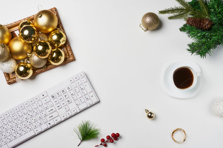 Minimalism. Flat lay Office desk table with computer keyboard and Christmas decoration and cup coffee on white backgraund. Top view with copy space.の写真素材
