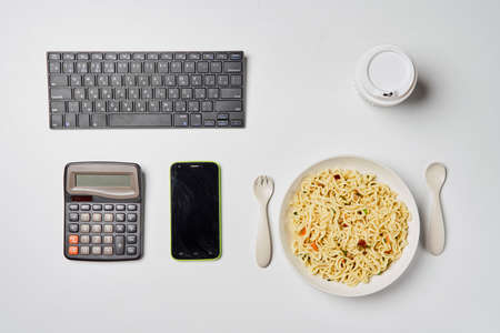 Instant noodles composition. Noodles and fresh vegetables and spices on white backgroundの写真素材
