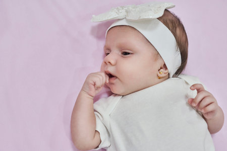 Baby Girl with white Flower Headband. 2-month-old baby girl.