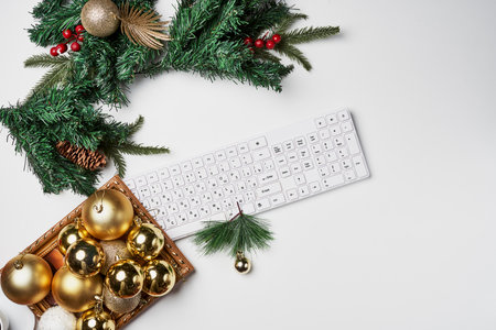 an office desk with christmas decorations and a computer keyboard on the desk, which is decorated with pine cones and gold ornamentsの写真素材