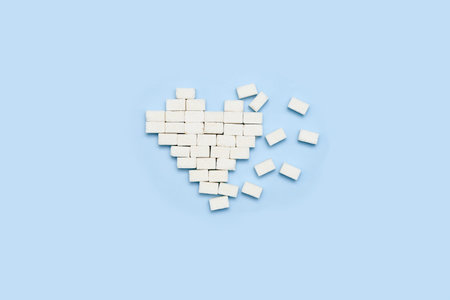 white sugar cubes on a blue background with the text, how to use sugar cubes in your marketing strategyの写真素材