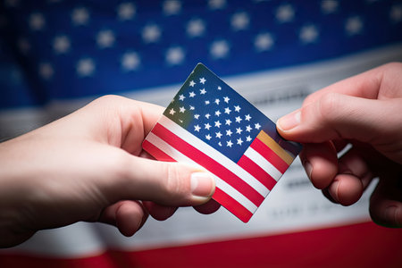 two hands holding an american flag with the us flag in the image is blurred and blured by the backgroundの素材