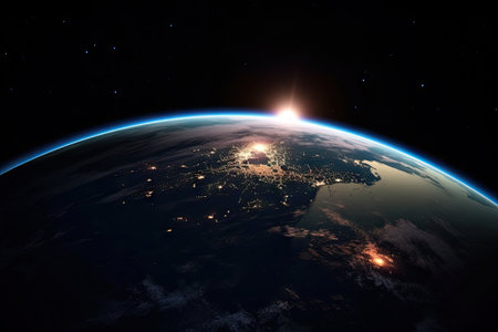 the earth from space, with lights shining in the distance and some stars on the horizon behind it stock photoの素材