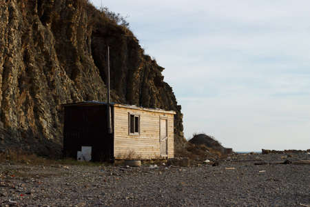 old wooden house on the background of rocksの写真素材