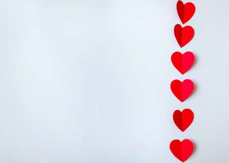 Valentine day background with red hearts, top view. White background with copy space. の写真素材