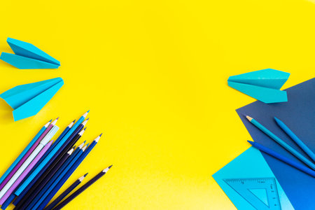 Creative, fashionable, minimalistic, school or office workspace with blue supplies on yellow...