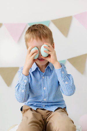 Adorable little boy with easter egg and bunny. Happy easter. Happy funny baby boy playing with...