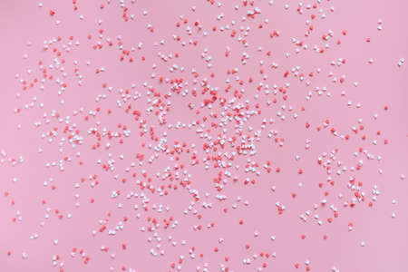 Banner. Small red, pink and white hearts on a trendy pink background. Happy Valentines Day, Mothers Day, March 8, holiday card concept. Flat lay.の写真素材