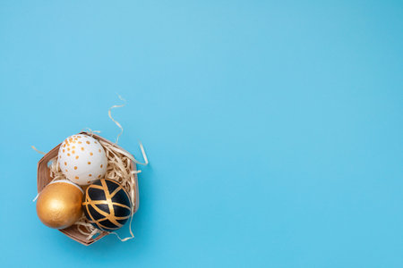 Top view of easter eggs colored with golden and black paint in differen patterns. Minimal easter...