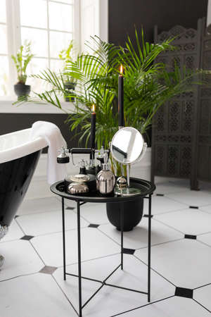 Modern White and Black Bathroom Interior Design. Body Skin Accessories. Water Tap Facility. Beauty Cosmetic Products Contemporary Apartment Concept Front View Stylish Roomの写真素材