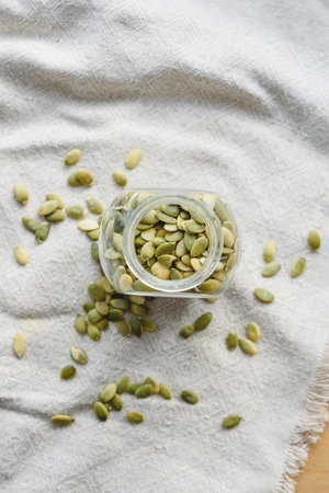 dried pumpkin seeds on linen cloth in a jar of glass