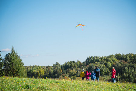 children's family launches a kite happiness and joyの写真素材