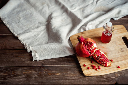 sliced pomegranate on a linen tablecloth, tree, dark backgroundの写真素材
