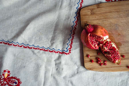 sliced pomegranate on a linen tablecloth, treeの写真素材