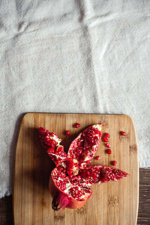 sliced pomegranate on a linen tablecloth, treeの写真素材