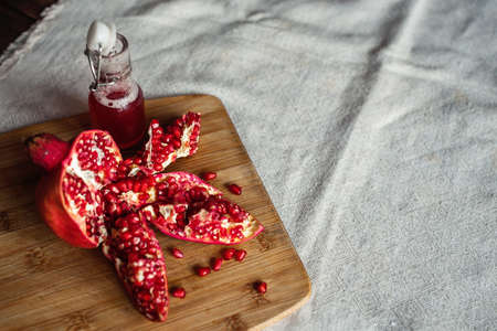 sliced pomegranate on a linen tablecloth, treeの写真素材