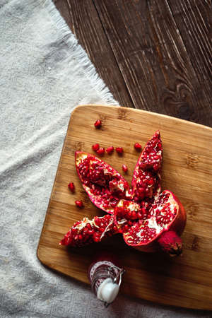 sliced pomegranate on a linen tablecloth, treeの写真素材