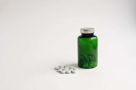 pills and green bank on a white backgroundの写真素材