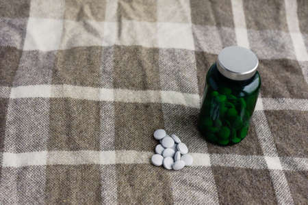 pills and green bank on a brown plaidの写真素材
