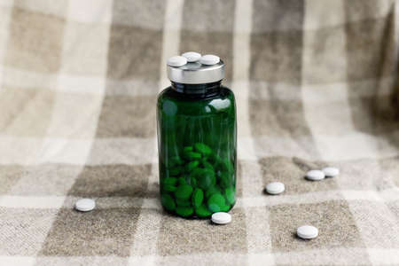 pills and green bank on a brown plaidの写真素材