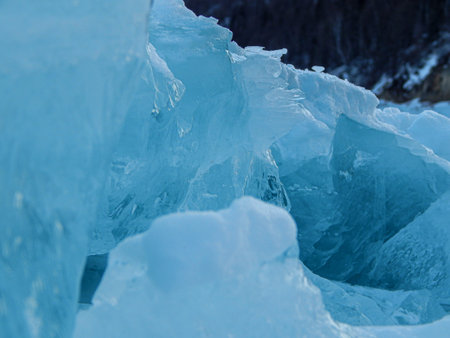 blue ice on the river in the winter forest