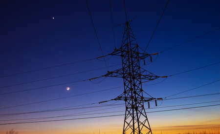 Electric tower on the background of night skyの写真素材