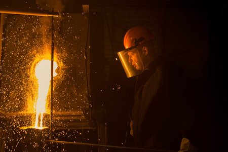smelter worker pours liquid metal into a casting mold