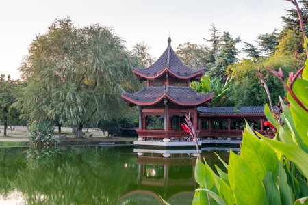 red old building in china with pagodas on the lake shoreの写真素材