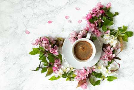 Coffee on the marble table. Apple tree flowers on a spring day. Women's desktopの写真素材