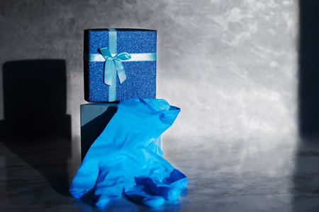 The blue gift box is open. Inside are blue medical gloves. Gift for Valentine's Day, wedding...