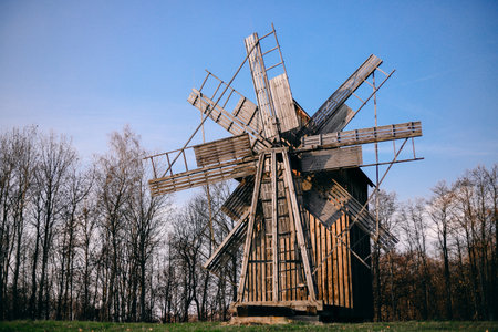 An old wooden windmill. The mills were used for grinding grain, wheat, and other legumes. An object of cultural heritage.の写真素材