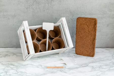 A white box with peat pots, coconut briquettes, and nameplates.の写真素材