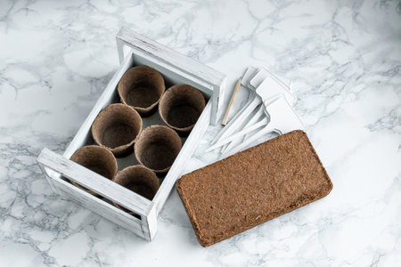 A white box with peat pots, coconut briquettes, and nameplates.の写真素材
