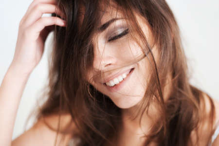 The pensive beautiful young girl smiles.の写真素材