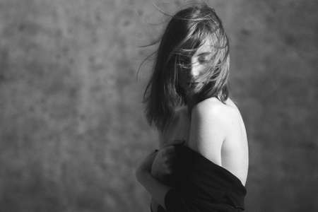 The woman  with the hair fluttering on a windの写真素材