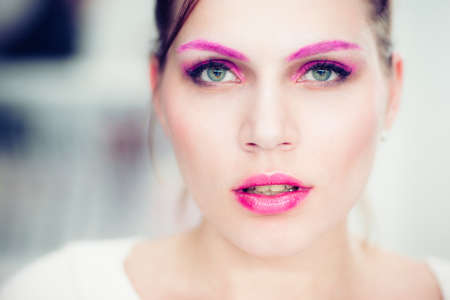 The woman with a bright pink make-up. Studio portrait.の写真素材