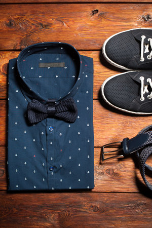 Man's collection of clothes in casual style consisting of a shirt with a bow tie, footwear...
