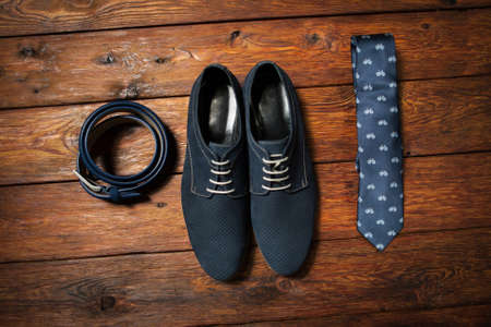 Set of fashionable man's accessories on darkly brown wooden backgroundの写真素材