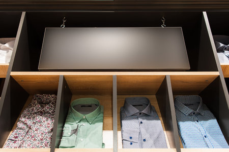 men's casuall shirts on a showwindow and a signboard in men's clothing shopの写真素材