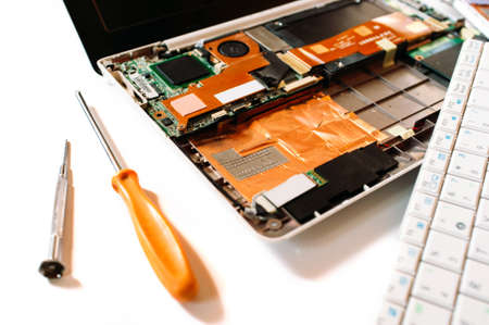 Closeup photo of the disassembled broken computer (laptop). Repair setの写真素材