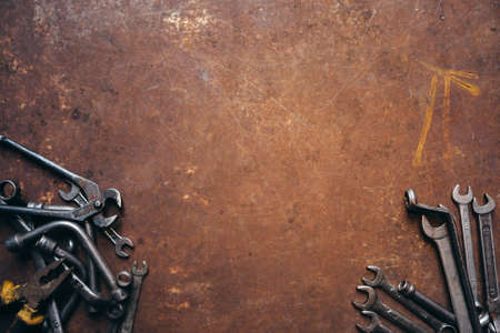 Set of different wrenches on a rusty dark metal backgroundの写真素材