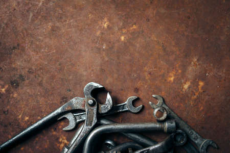 Set of different wrenches on a rusty dark metal backgroundの写真素材