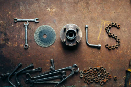 the word Tools made of the different tools lying on a rusty metal background.の写真素材