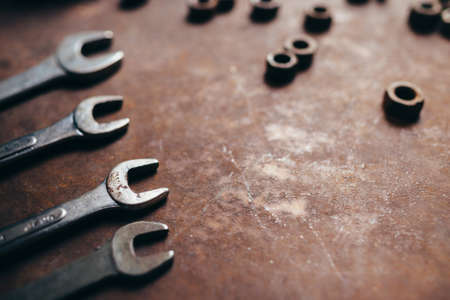 Wrenches and nuts on a rusty metal background. Beautiful art photoの写真素材
