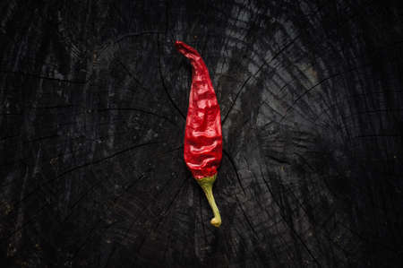 Hot red pepper lies on a dark boardの写真素材