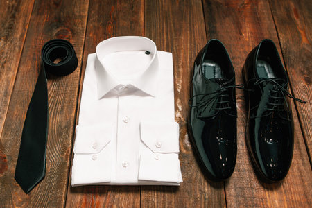 stylish collection of men's clothing. Black tie , patent leather shoes , a white shirt - wedding set for the groom . top view.の写真素材