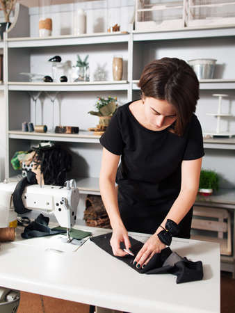 Seamstress creates a sketch on  the fabric. designer sews clothesの写真素材