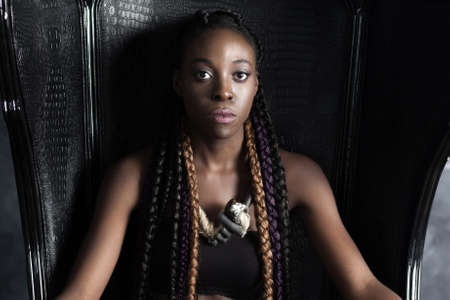young confident calm braided afro-american woman sittingの写真素材